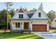 Charming two-story home featuring a manicured lawn, double-door entrance, and a striking two-car garage at 12845 Mallard Rock Rd, Zebulon, NC 27597