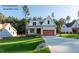 Beautiful new construction home with a well-manicured front lawn and a long concrete driveway at 12845 Mallard Rock Rd, Zebulon, NC 27597