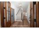 Lovely foyer with beautiful hardwood floors, stairs to the second story, and glass paneled doors at 12845 Mallard Rock Rd, Zebulon, NC 27597