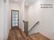 Hallway with a wooden staircase and a glass panel door at 12845 Mallard Rock Rd, Zebulon, NC 27597