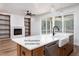Open kitchen with hardwood flooring, farmhouse sink, and views into the living room at 12845 Mallard Rock Rd, Zebulon, NC 27597