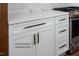 The kitchen features white cabinets with black and gold hardware and quartz countertops at 12845 Mallard Rock Rd, Zebulon, NC 27597