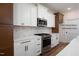 The kitchen features stainless steel appliances, white cabinets, and gold hardware at 12845 Mallard Rock Rd, Zebulon, NC 27597