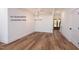 Open concept living room with hardwood floors and white walls with lots of natural light at 12845 Mallard Rock Rd, Zebulon, NC 27597