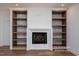 Living room featuring a cozy fireplace and built-in bookshelves at 12845 Mallard Rock Rd, Zebulon, NC 27597