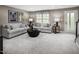 Cozy living room with neutral tones, plush seating, and ample natural light, perfect for relaxation and entertaining at 1349 Chowan Ave, Durham, NC 27713