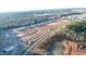 Aerial view of a new neighborhood under construction and lined with mature trees at 149 Gladstone Loop, Clayton, NC 27520