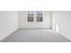 Bright bedroom with neutral carpet, showcasing a view from the double windows at 149 Gladstone Loop, Clayton, NC 27520