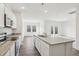 Bright kitchen features stainless steel appliances, and a large island with sink and granite countertops at 149 Gladstone Loop, Clayton, NC 27520
