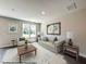 Cozy living room with large windows, comfortable seating, and stylish decor at 15 Calluna Dr, Clayton, NC 27520