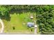 Expansive aerial view of the property with house, outbuilding and large, well-maintained yard at 1510 Asbury Church Rd, Sanford, NC 27330
