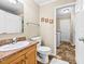 Bathroom featuring a single sink vanity, toilet, and tile flooring at 1510 Asbury Church Rd, Sanford, NC 27330