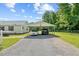 Two-car carport with gravel driveway and adjacent well-kept lawn at 1510 Asbury Church Rd, Sanford, NC 27330