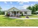 Charming single-story home featuring a covered front porch and well-manicured lawn at 1510 Asbury Church Rd, Sanford, NC 27330