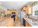 Functional kitchen features a refrigerator, black appliances, and tile flooring at 1510 Asbury Church Rd, Sanford, NC 27330
