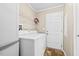 Functional laundry room featuring washer, dryer, shelving and access to the back at 1510 Asbury Church Rd, Sanford, NC 27330