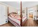 Inviting main bedroom boasts a four-poster bed and wood-look flooring at 1510 Asbury Church Rd, Sanford, NC 27330