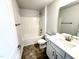Cozy bathroom with a shower-tub combo, single sink vanity, and dark tile flooring at 1667 Pecan Drive # 25, Nashville, NC 27856