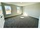 Bedroom with two windows letting in natural light and gray carpet at 1667 Pecan Drive # 25, Nashville, NC 27856