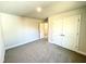 This bedroom features neutral walls, gray carpet, and a double-door closet at 1667 Pecan Drive # 25, Nashville, NC 27856