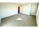 Spacious bedroom with neutral walls and gray carpet with doors leading to more space at 1667 Pecan Drive # 25, Nashville, NC 27856