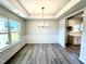 Bright dining area with large windows, modern chandelier, and an open view to the adjacent kitchen space at 1667 Pecan Drive # 25, Nashville, NC 27856