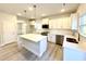 Modern kitchen with stainless steel appliances, quartz countertops, and an island with bar seating at 1667 Pecan Drive # 25, Nashville, NC 27856