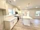 The spacious kitchen has white cabinets, a center island, stainless steel appliances, and recessed lighting at 1667 Pecan Drive # 25, Nashville, NC 27856