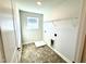 This laundry room has a window, wire shelving and gray tile flooring at 1667 Pecan Drive # 25, Nashville, NC 27856