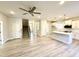 Open-concept living area featuring wood-look flooring, a ceiling fan, and easy access to the kitchen at 1667 Pecan Drive # 25, Nashville, NC 27856
