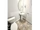 This powder room includes a pedestal sink, oval mirror and tile flooring at 1667 Pecan Drive # 25, Nashville, NC 27856