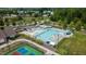 Aerial view of community pool with clear blue water, lounge chairs, and surrounding amenities like a playground at 1910 Morehead Hill Ct, Durham, NC 27703