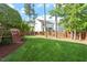 Spacious backyard with lush green lawn, wooden fence, and mature trees perfect for outdoor activities and relaxation at 1910 Morehead Hill Ct, Durham, NC 27703