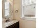 Powder room featuring a round mirror and granite countertop at 1910 Morehead Hill Ct, Durham, NC 27703