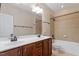 Bathroom with double sink vanity, full-sized mirror, and a tub/shower with tile surround at 1910 Morehead Hill Ct, Durham, NC 27703
