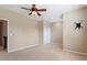 A bright bedroom features neutral walls, carpeted floors, and a ceiling fan, offering a serene and comfortable living space at 1910 Morehead Hill Ct, Durham, NC 27703