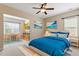 Charming bedroom showcasing a blue comforter bed, desk area and vibrant wall art, perfect for a space at 1910 Morehead Hill Ct, Durham, NC 27703