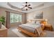 Spacious bedroom with trey ceiling, ceiling fan, and large window at 1910 Morehead Hill Ct, Durham, NC 27703