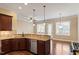 Kitchen with granite countertops, dark wood cabinets, and stainless steel appliances at 1910 Morehead Hill Ct, Durham, NC 27703