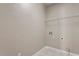 A well-lit laundry room features connections for a washer and dryer and has tile flooring at 1910 Morehead Hill Ct, Durham, NC 27703