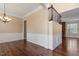 Open room with hardwood floors, crown molding, and stone fireplace at 1910 Morehead Hill Ct, Durham, NC 27703