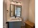 Bathroom with single sink vanity with a quartz countertop and black hardware at 200 Broadleaf Ln, Louisburg, NC 27549