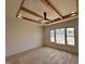 Bright bedroom with wood beam tray ceiling and large windows offering scenic views at 200 Broadleaf Ln, Louisburg, NC 27549