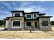 Stunning new home featuring stone and white siding, complemented by dark trim and a welcoming entryway at 200 Broadleaf Ln, Louisburg, NC 27549