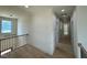 Upstairs hallway with hardwood floors, white walls, and black metal banister at 200 Broadleaf Ln, Louisburg, NC 27549