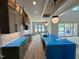 Open-concept kitchen featuring modern cabinetry, an island with seating, and a seamless flow to living spaces at 200 Broadleaf Ln, Louisburg, NC 27549