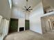 Grand living room with soaring ceilings, fireplace, and expansive windows at 200 Broadleaf Ln, Louisburg, NC 27549