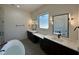 Luxurious main bathroom featuring dual vanities, soaking tub, and modern fixtures at 200 Broadleaf Ln, Louisburg, NC 27549