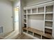 Mudroom with built-in shelves, wooden bench, and hardwood flooring at 200 Broadleaf Ln, Louisburg, NC 27549