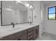This bathroom has double sinks, black hardware, and tile flooring at 200 Broadleaf Ln, Youngsville, NC 27596